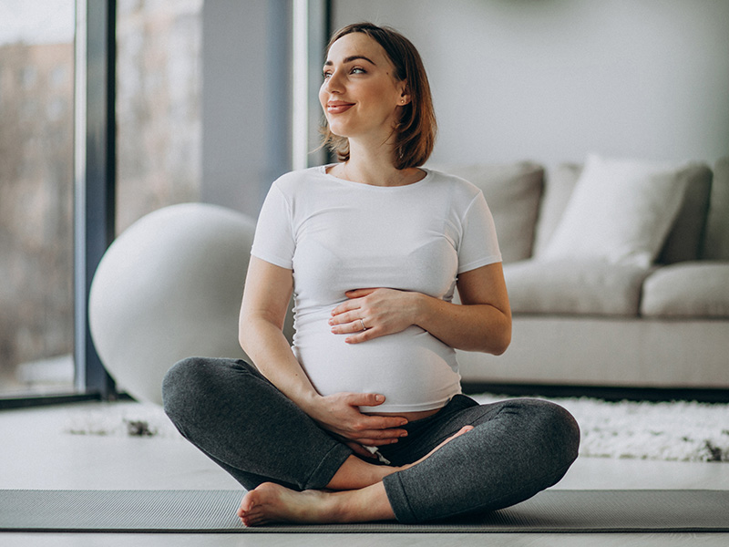 Pregnant woman sitting on floor