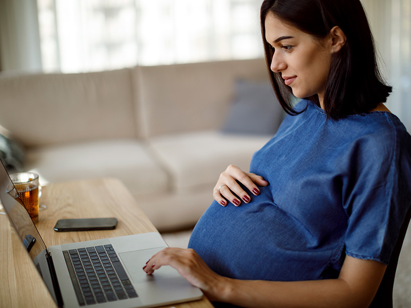 Pregnant woman on laptop