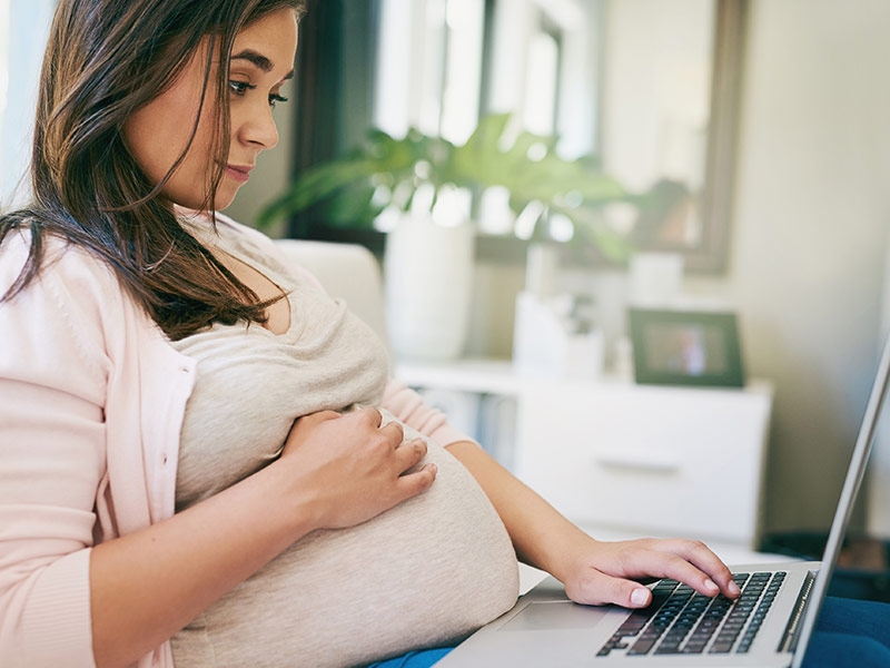 Pregnant woman on laptop