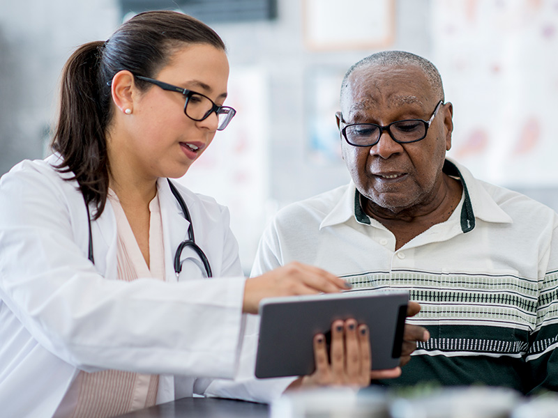 Provider with patient looking at tablet