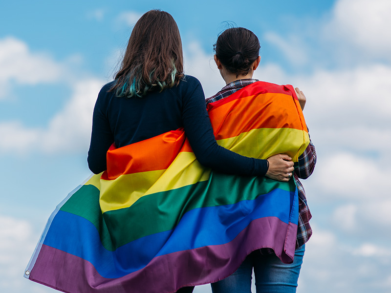 Women with LGBTQ Flag