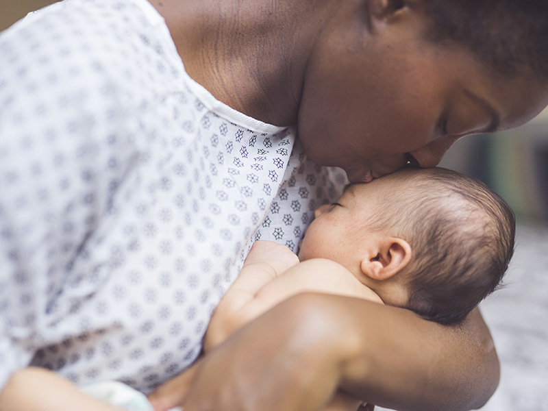 Mom kissing baby