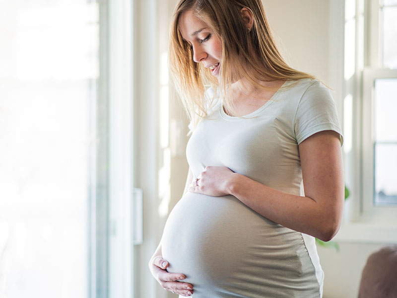 Pregnant holding stomach