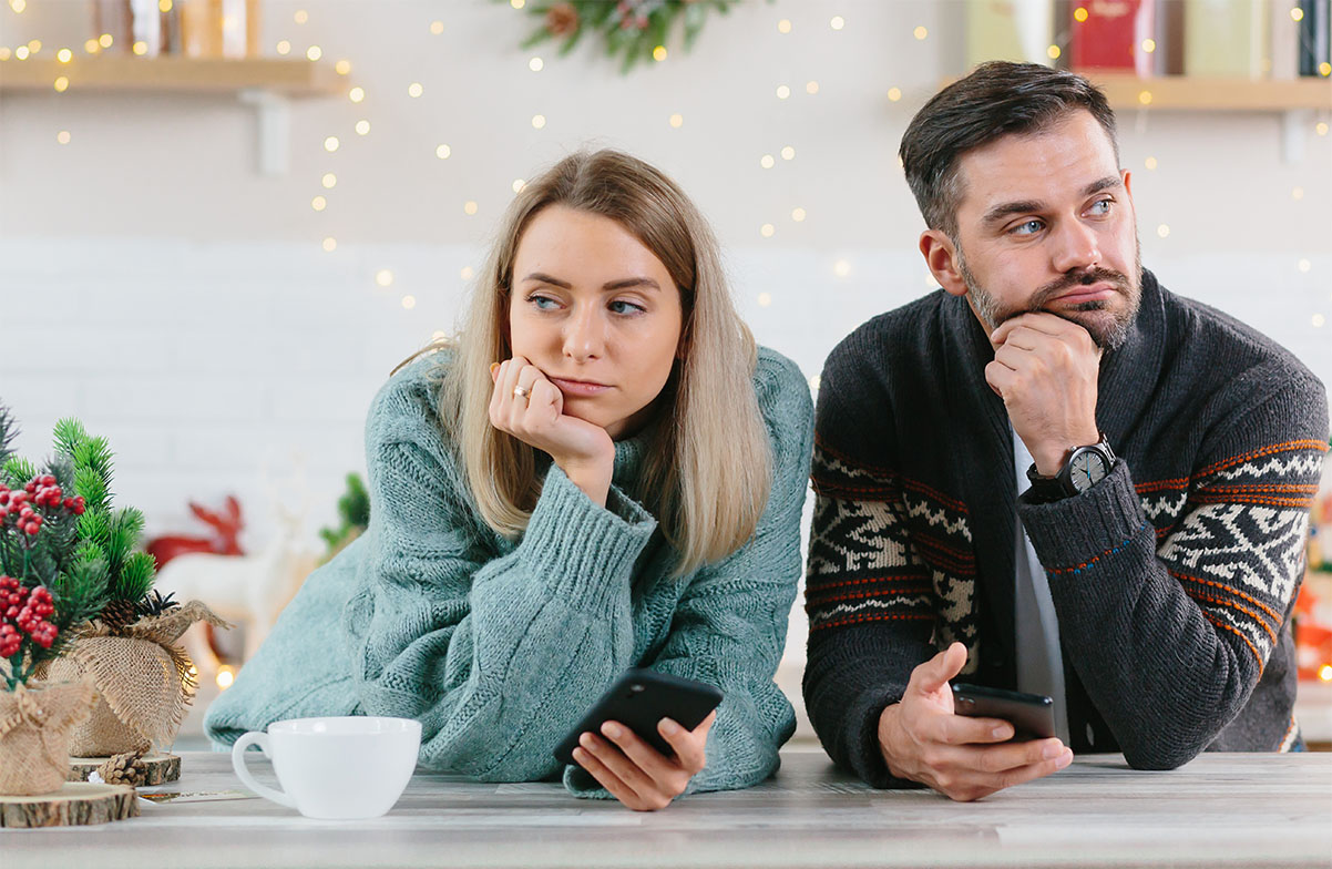 Young couple who look tired at Christmas