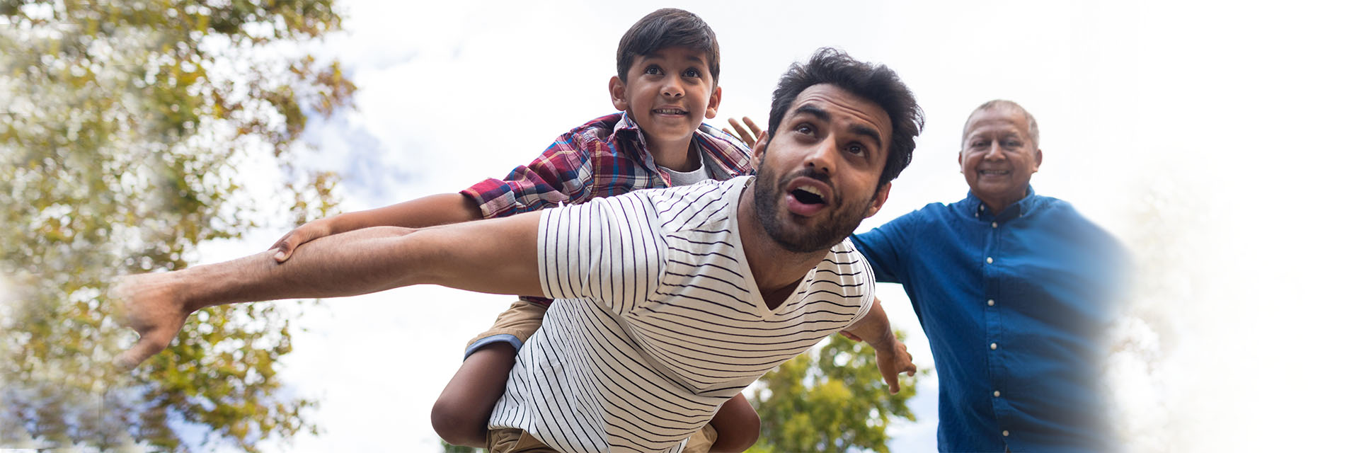 Son, father and grandfather playing outdoors