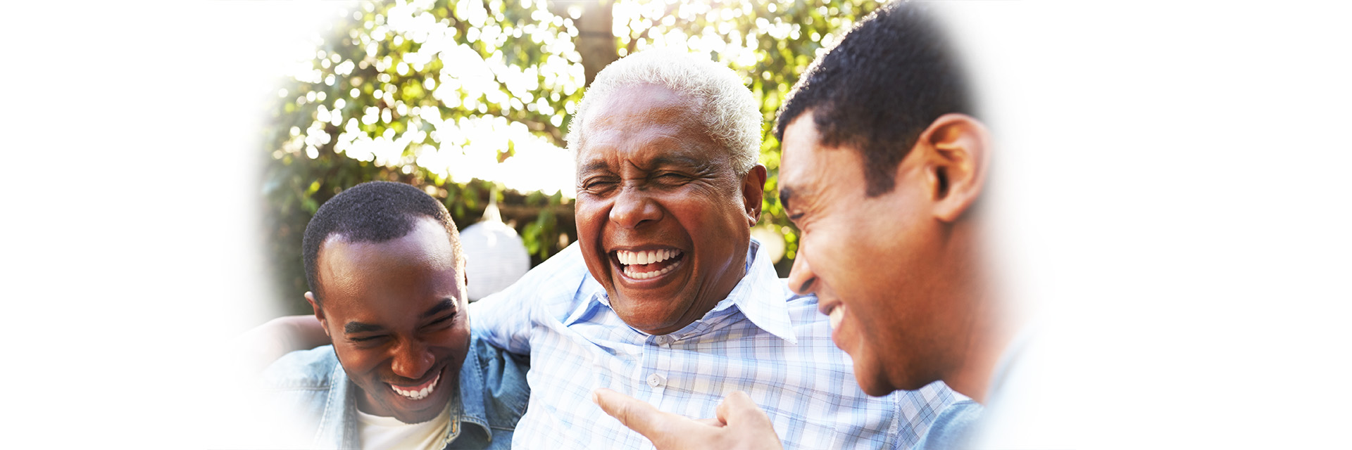 Grandfather, father and son laughing