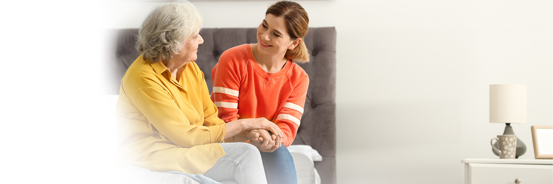 Younger woman and older woman sitting on a couch 