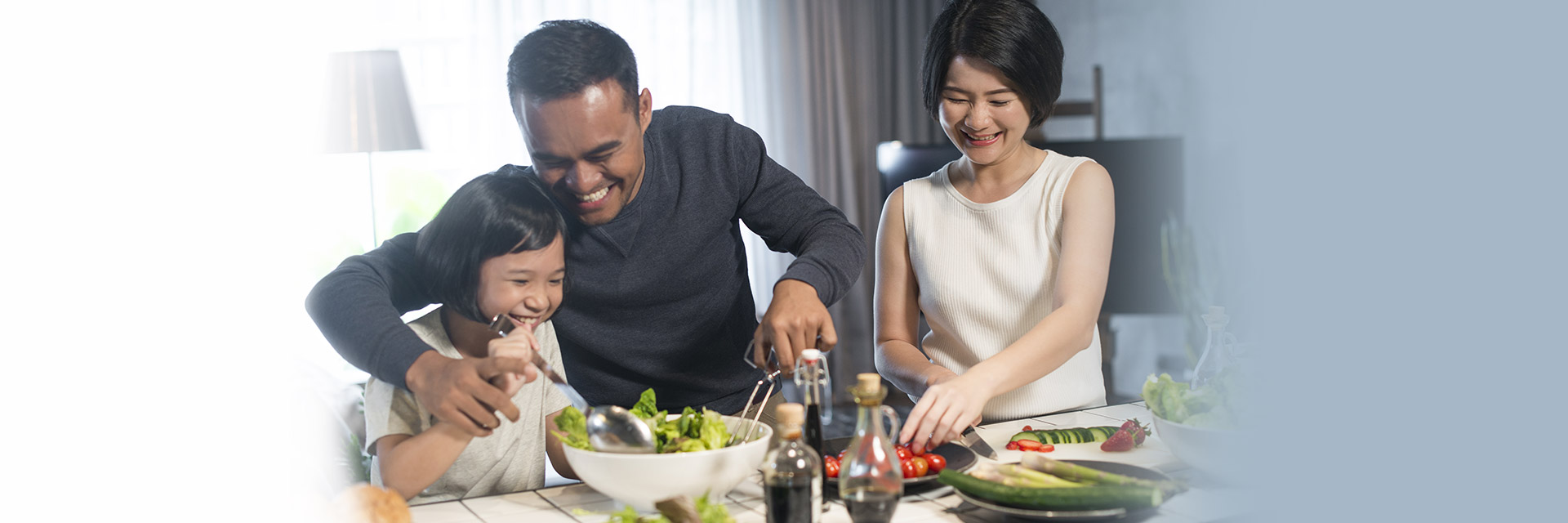 Family preparing and eating salad