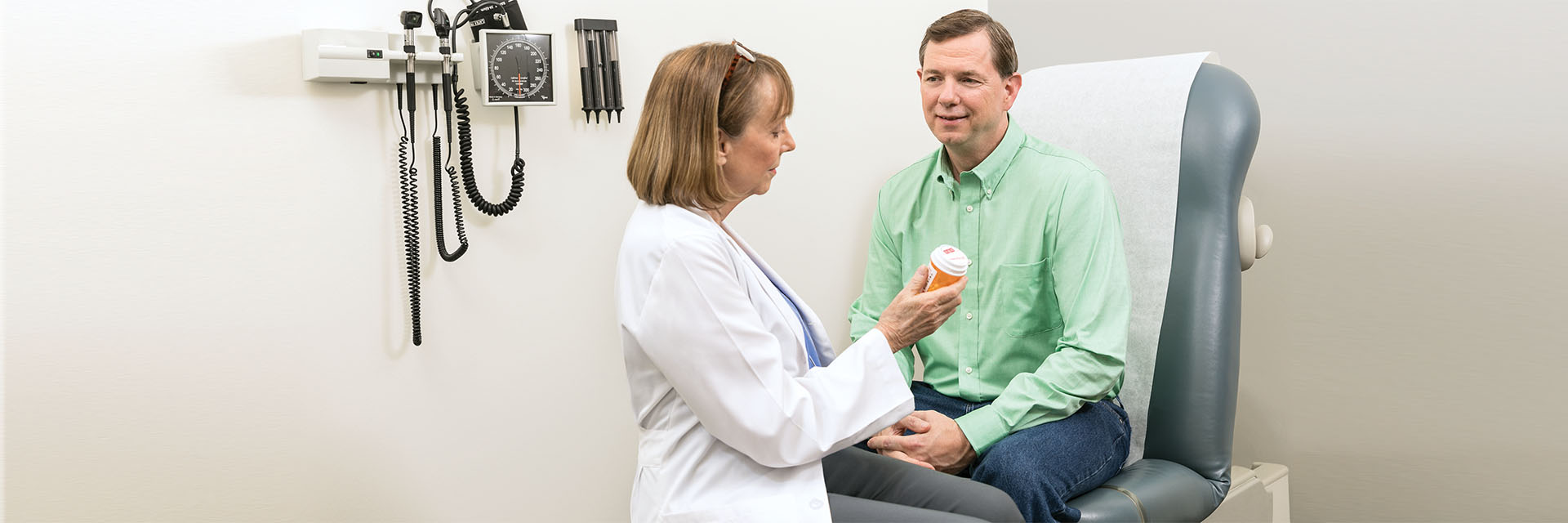 Female provider consulting with older male patient