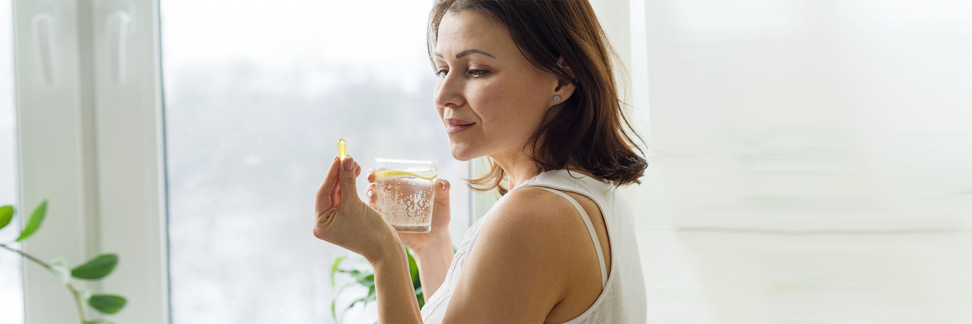 Woman taking clear capsule