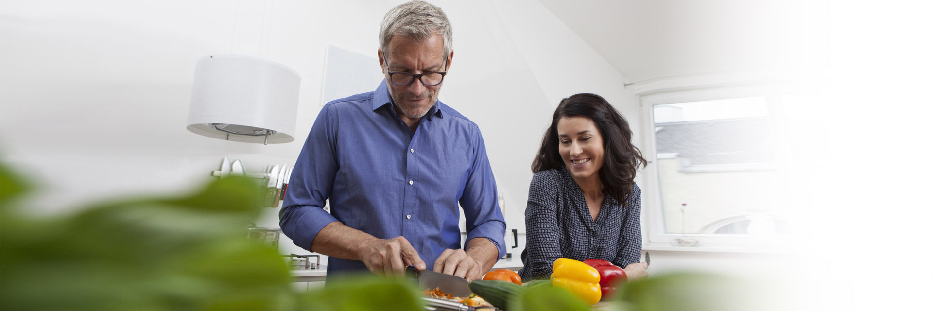 Mature couple cooking healthy in the kitchen