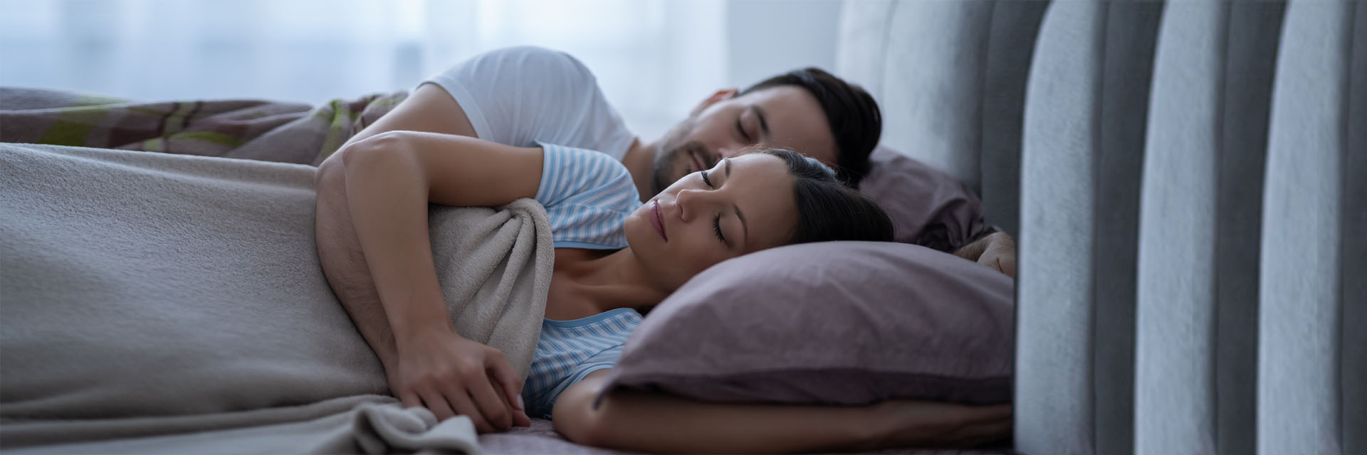Couple resting and smiling in bed