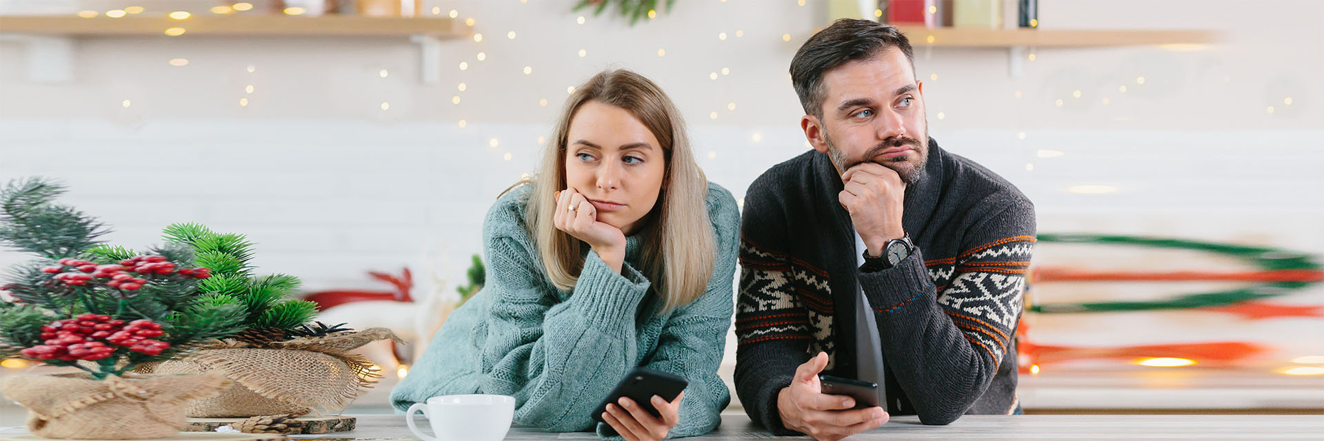 Young couple looking sad with holiday decorations 