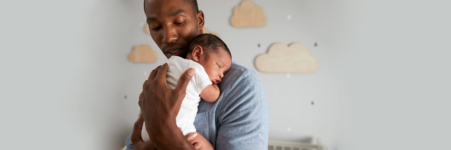 Dad holding newborn baby