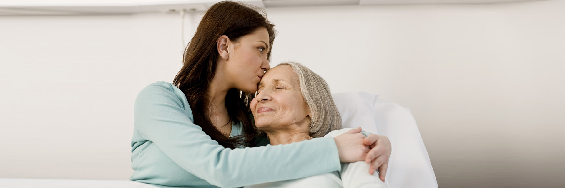 Worried daughter hugging smiling mother