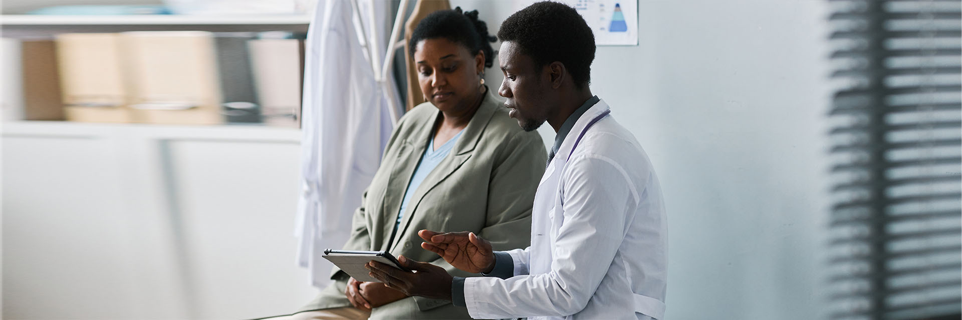 Male and female patient talking in his office