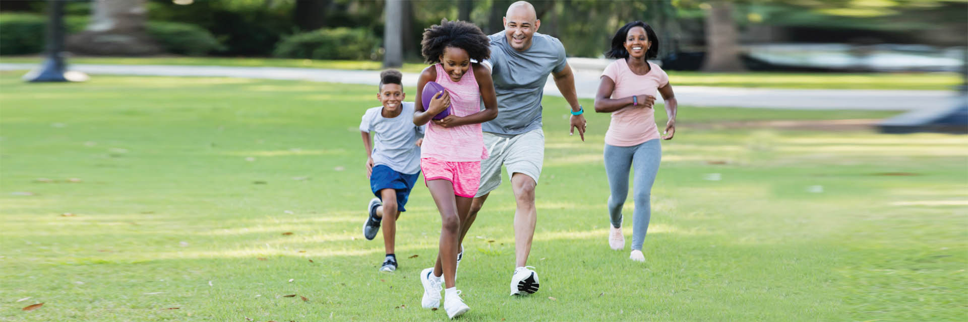 Family playing football outdoors