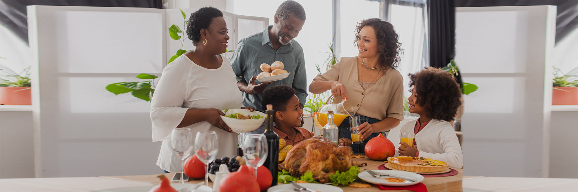 Diverse group standing near turkey in kitchen