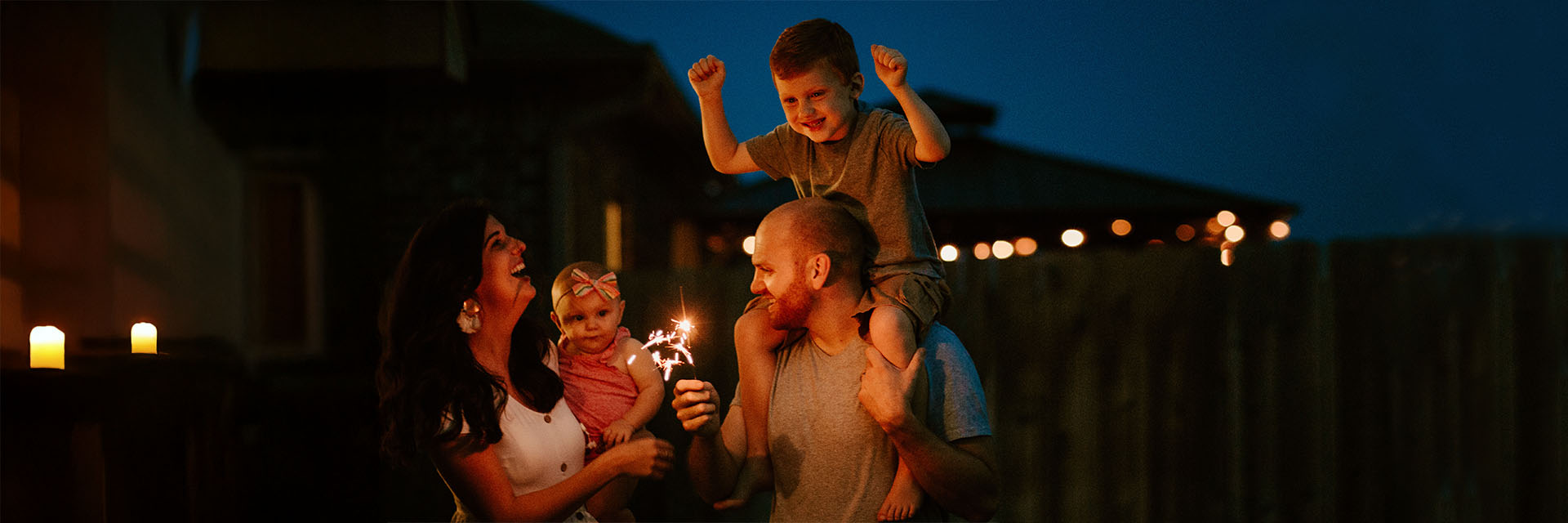 Mom, Dad and children with fireworks outdoors