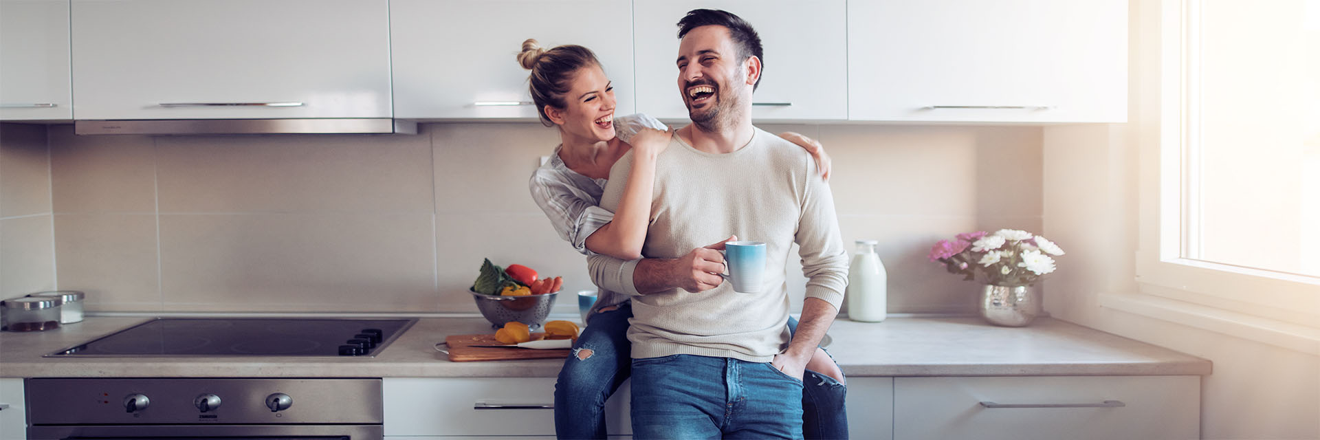 Young couple smiling in kitchen