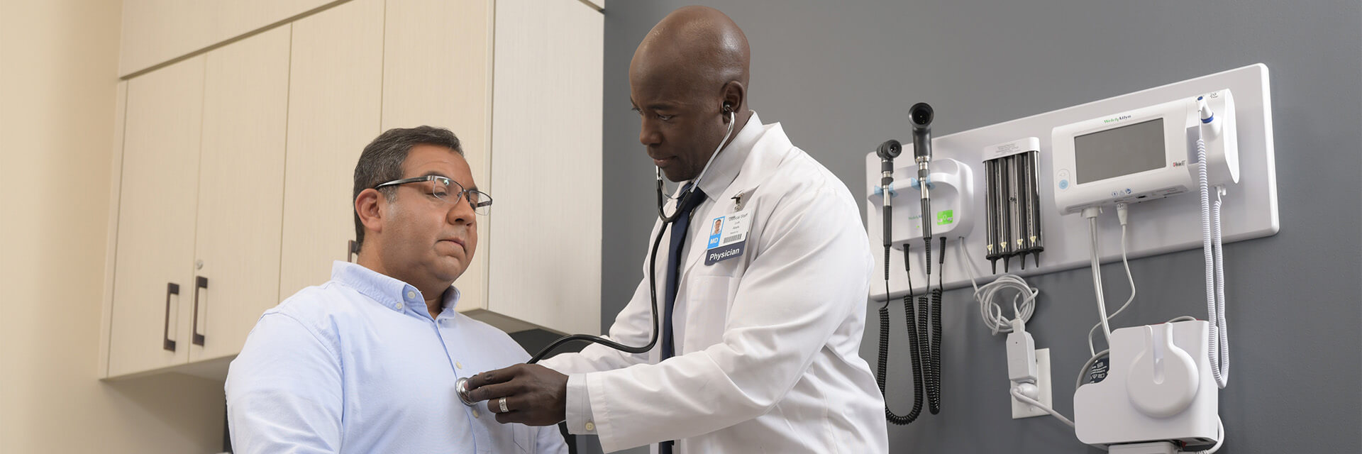 Male patient getting checkup in office