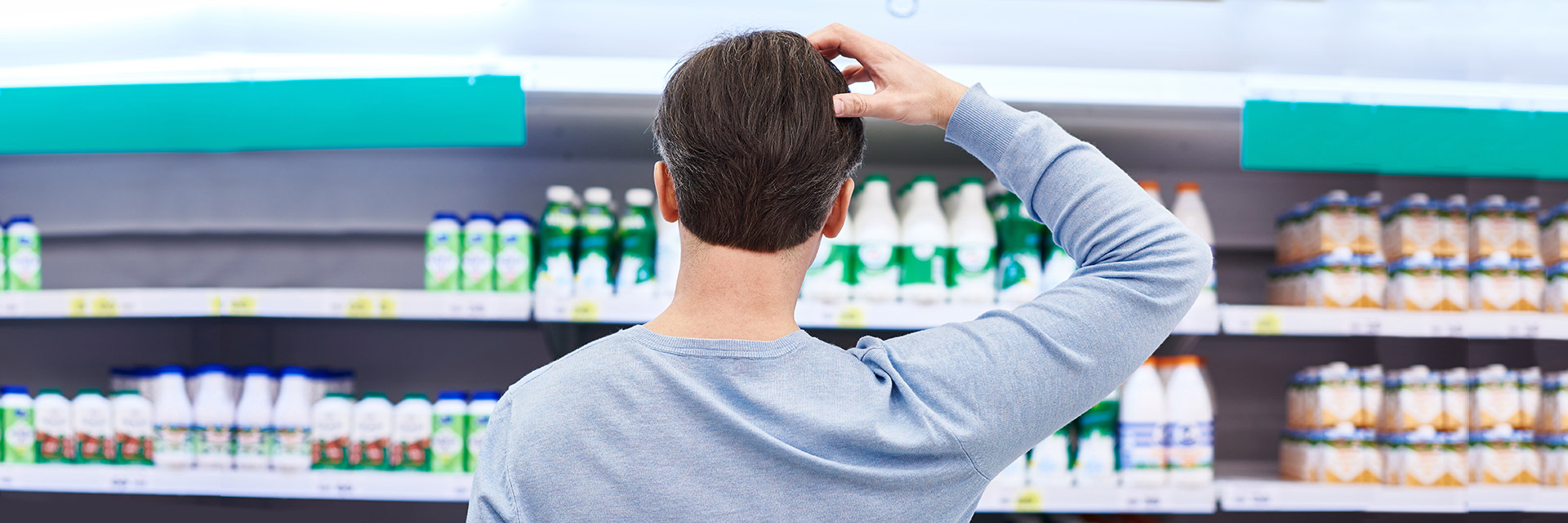 Man choosing product in grocery store