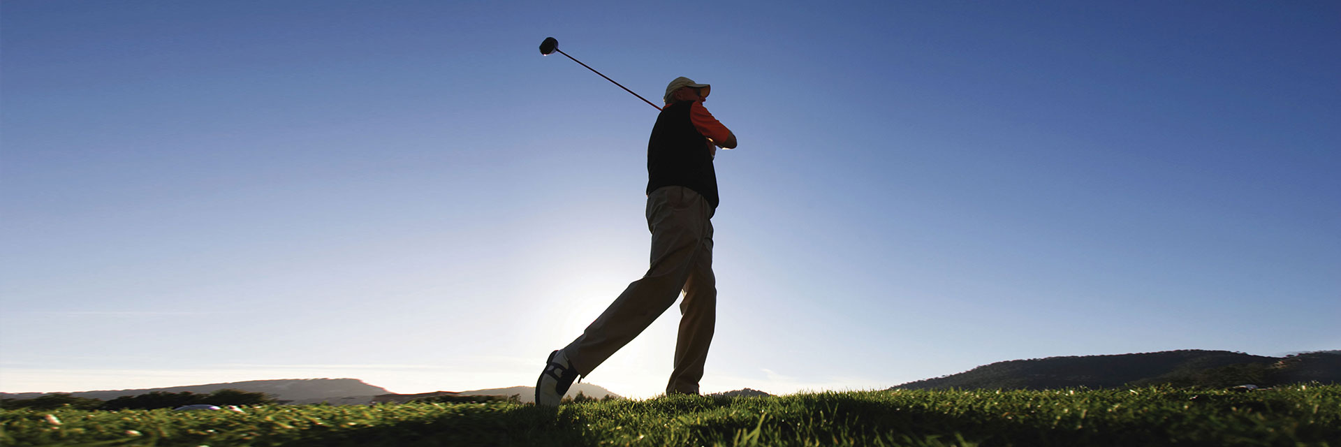 Man playing golf outdoors