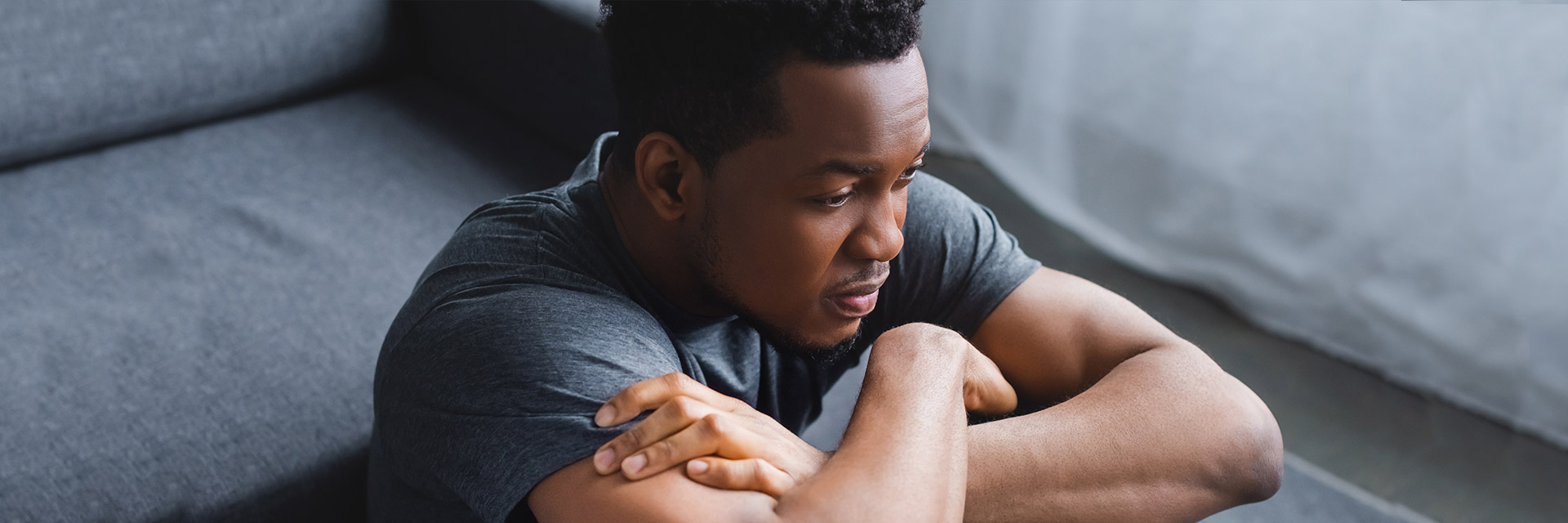 Worried man sitting on the floor