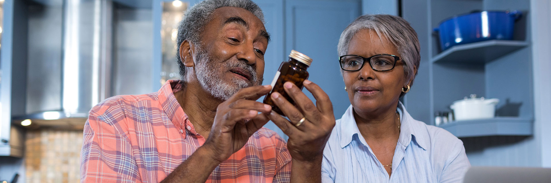 Mature Couple looking at medicine bottle