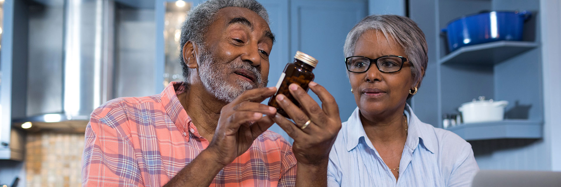 Mature Couple looking at medicine bottle