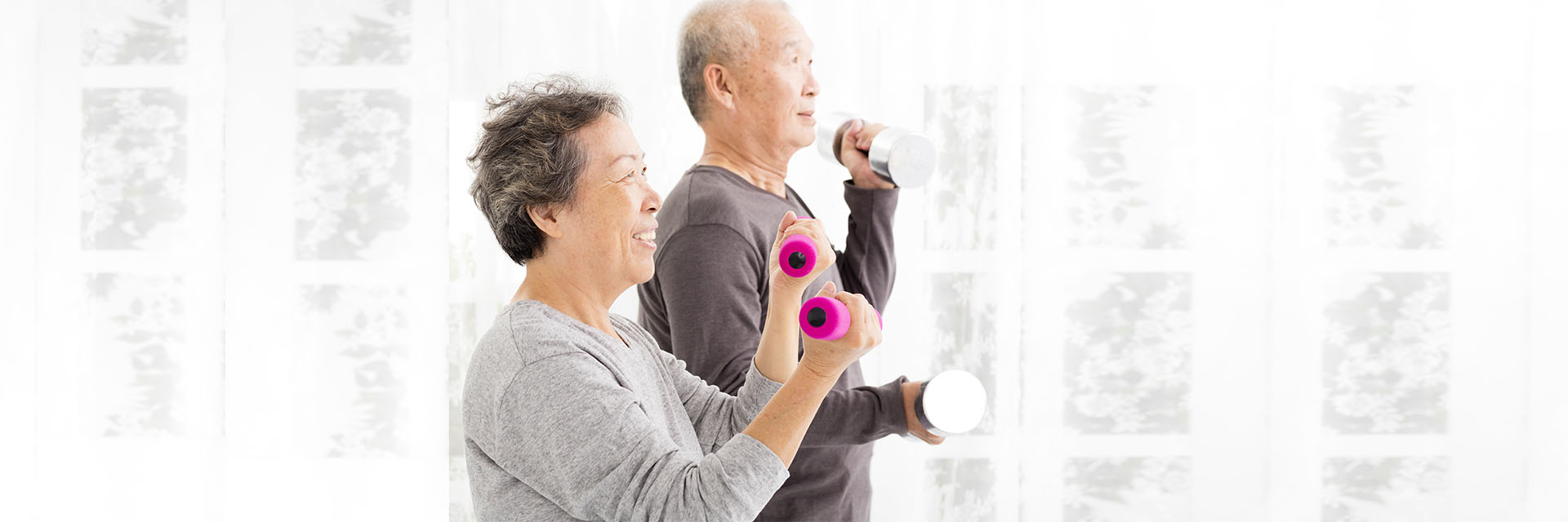 Mature Couple lifting weights