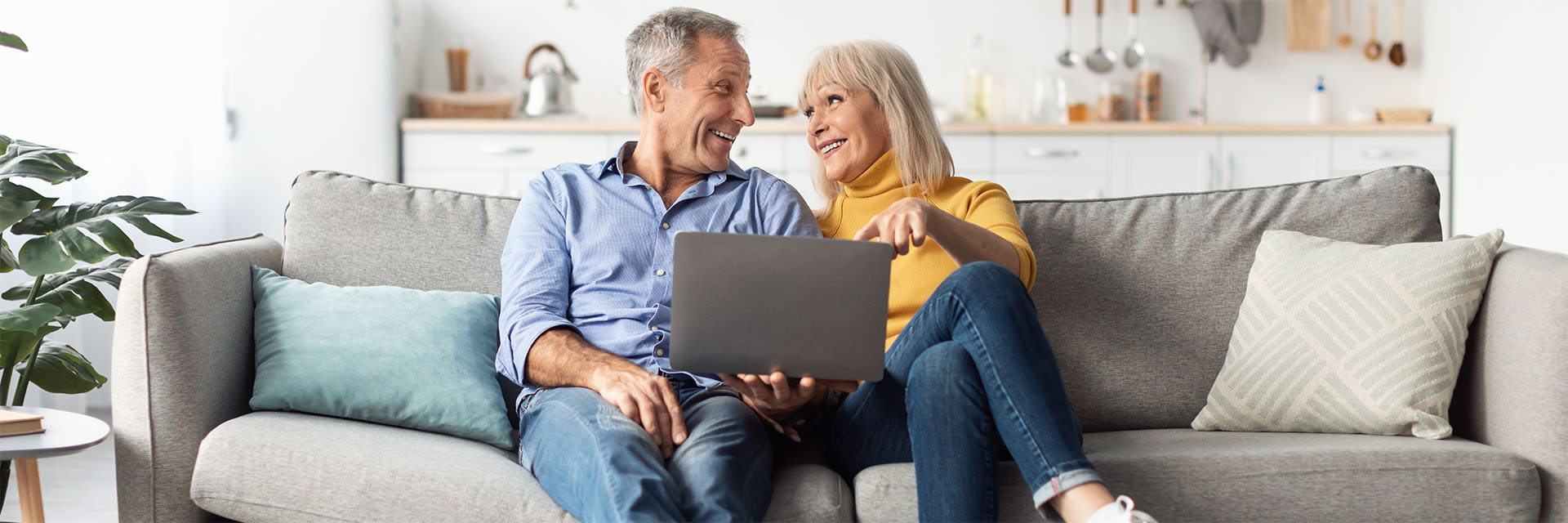 Mature Couple smiling at laptop