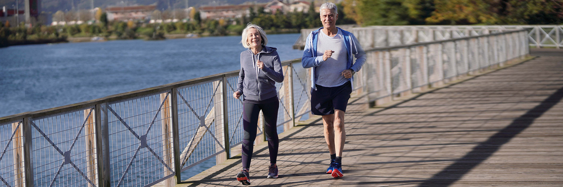 Mature Couple jogging by lake