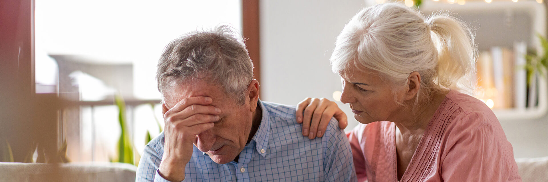 Mature Couple with man holding his head