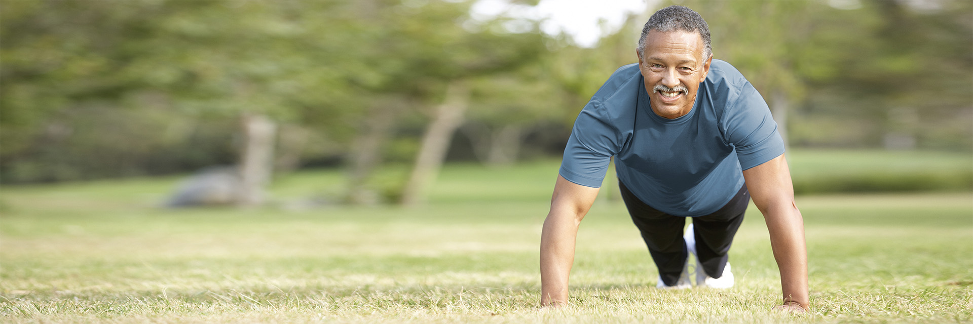 Mature man dong pushups outdoors