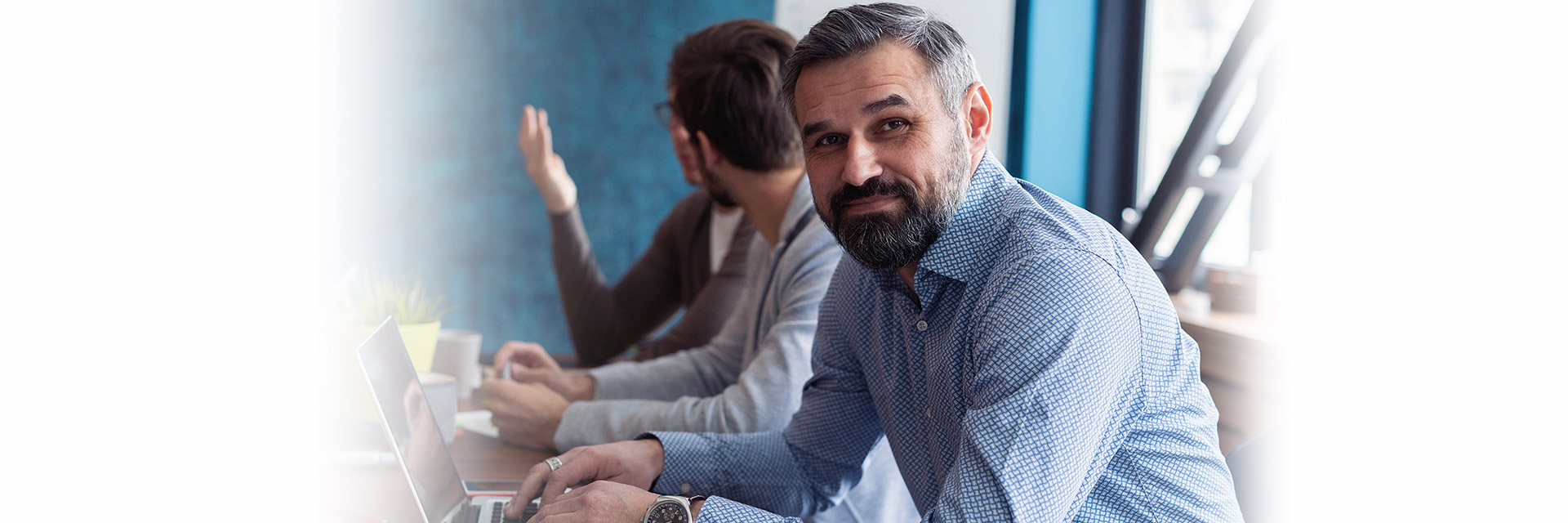 Man smiling at a meeting