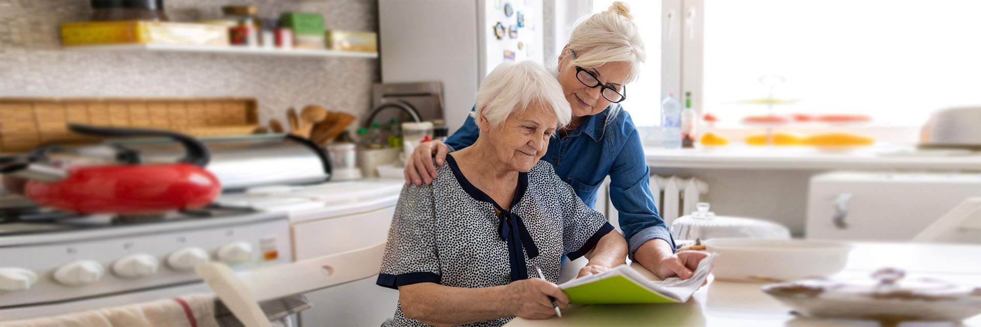 Mature mother and daughter at the kitchen table