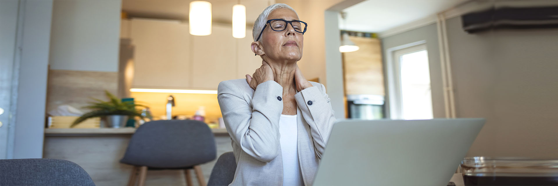 Stressed mature woman rubbing her neck 