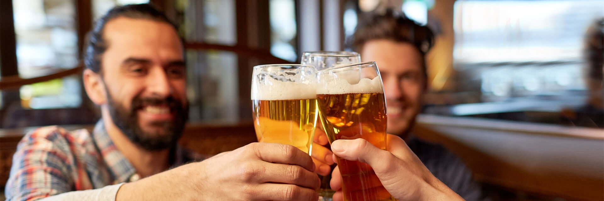Men holding glassing toasting in restaurant