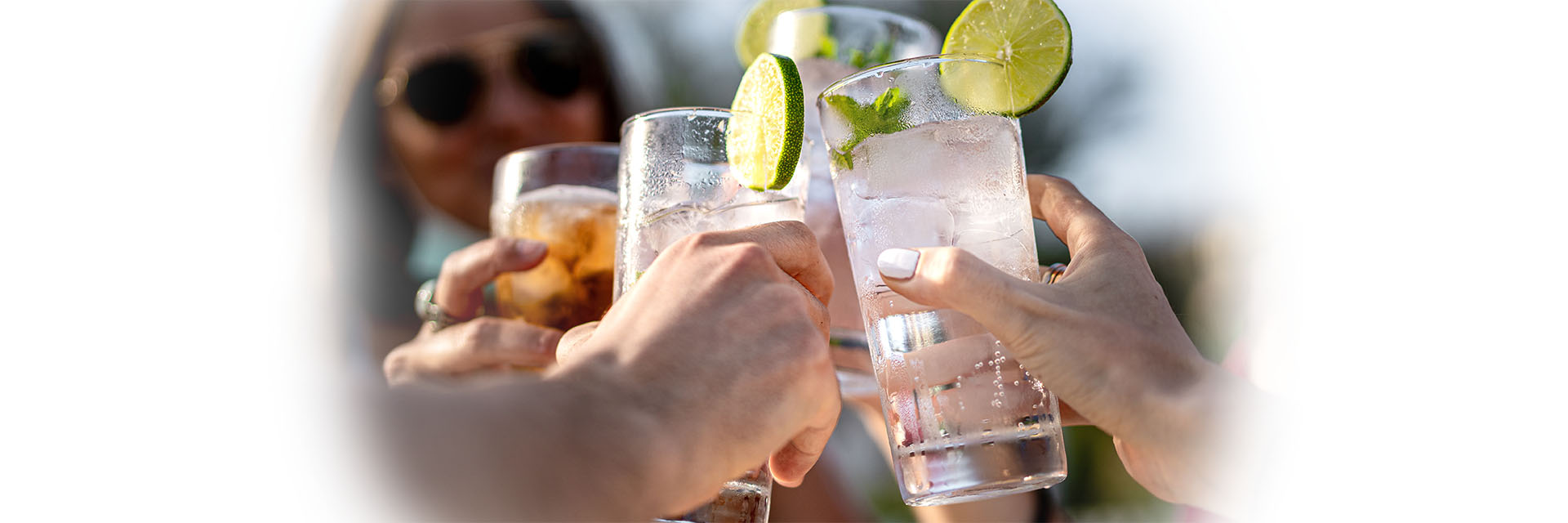 People outdoors toasting with drinks outdoors