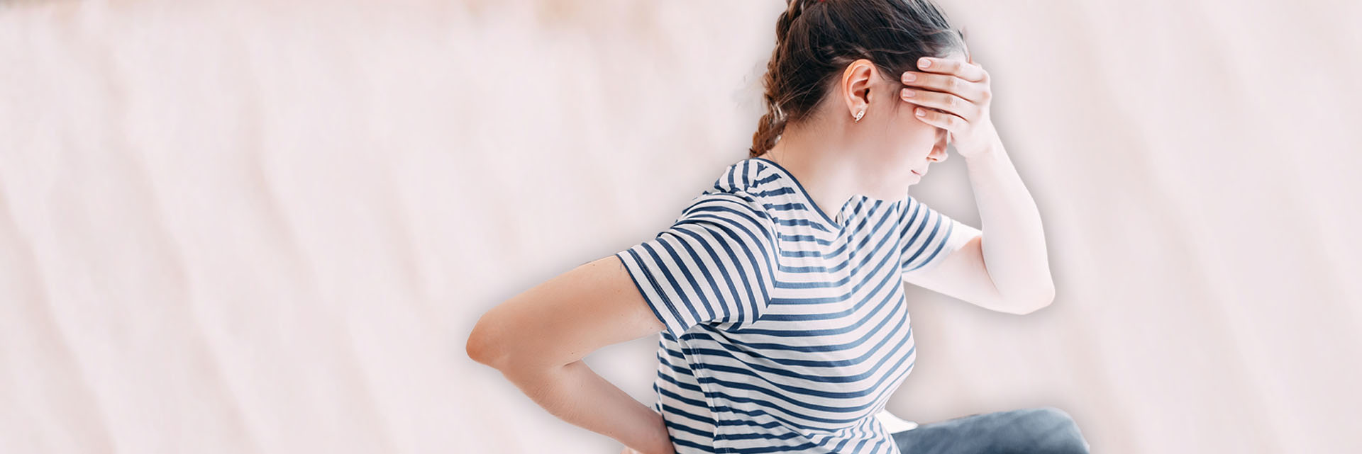 Woman holding her head in pain