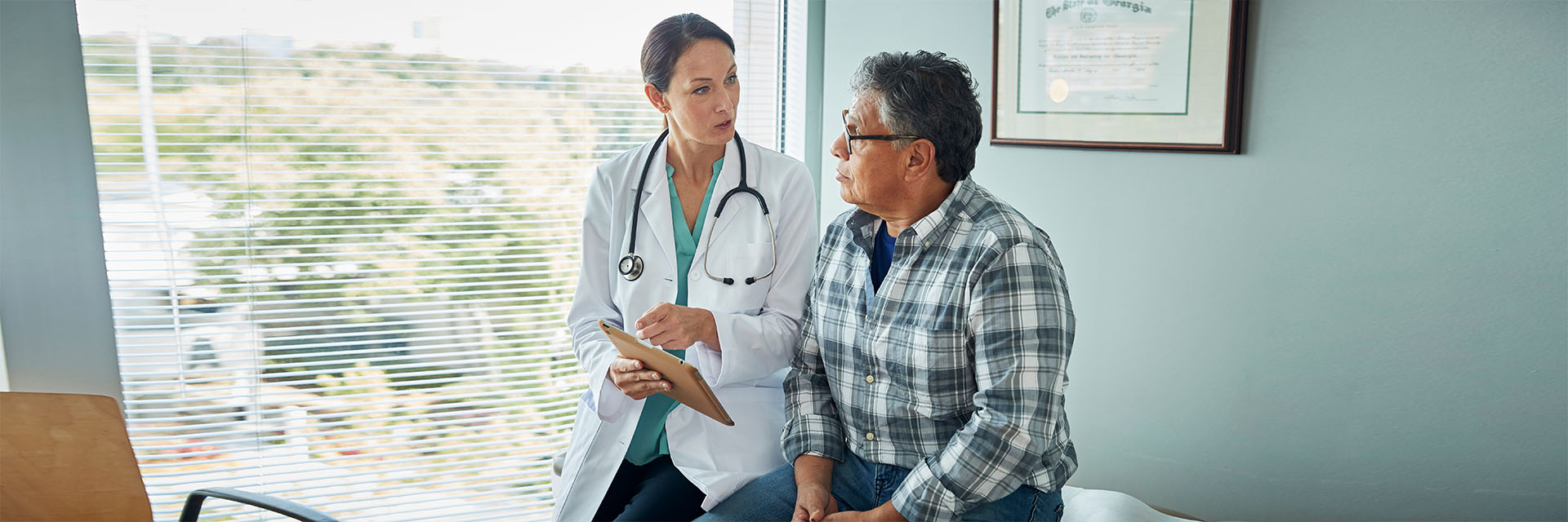 Man talking to his doctor in the exam room