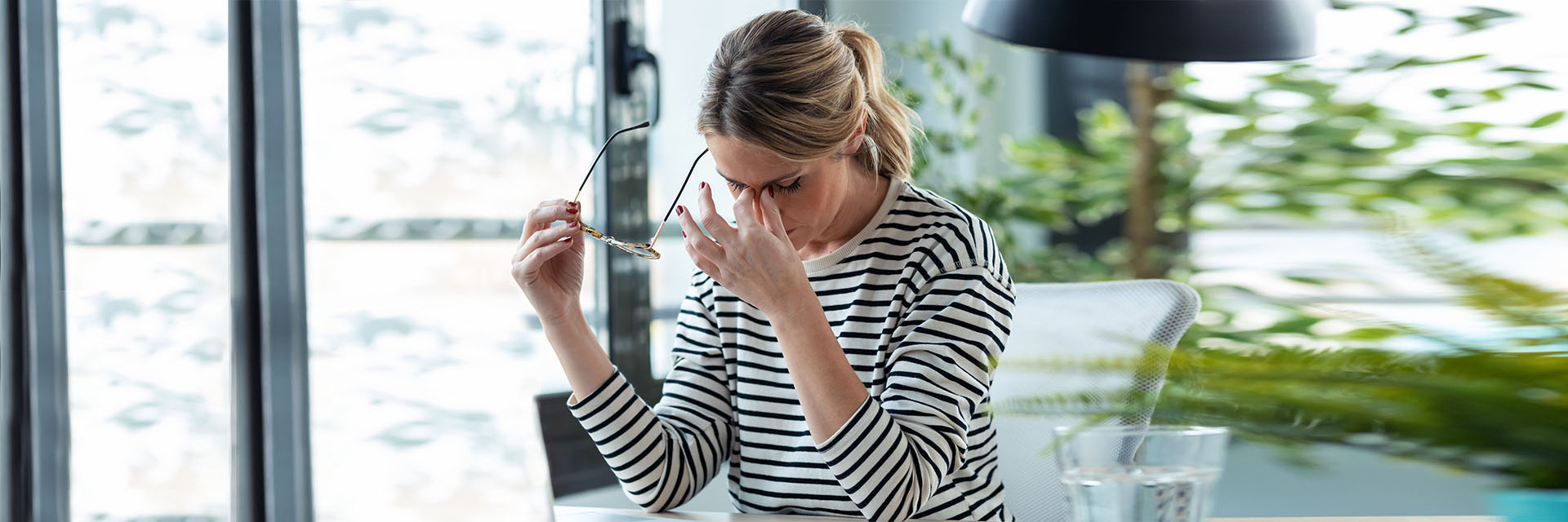Stressed mature business woman looking worried, tired and overwhelmed