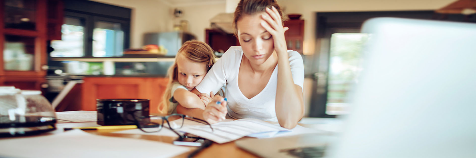 Stressed mom in front of the computer with her daughter