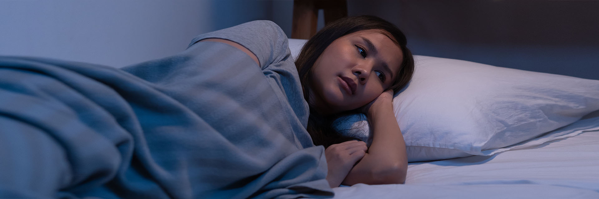 Woman awake laying in bed