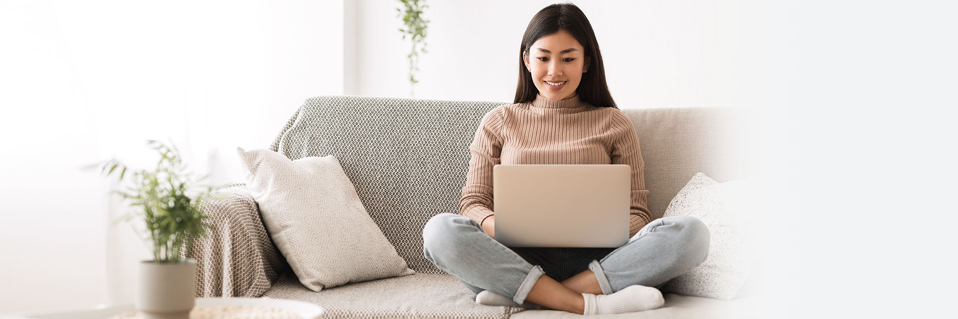 Young Woman on the couch with her laptop