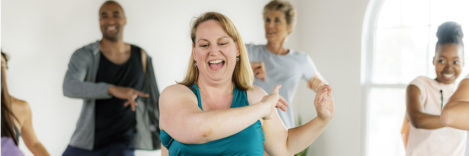 Plus size woman dancing in fitness class