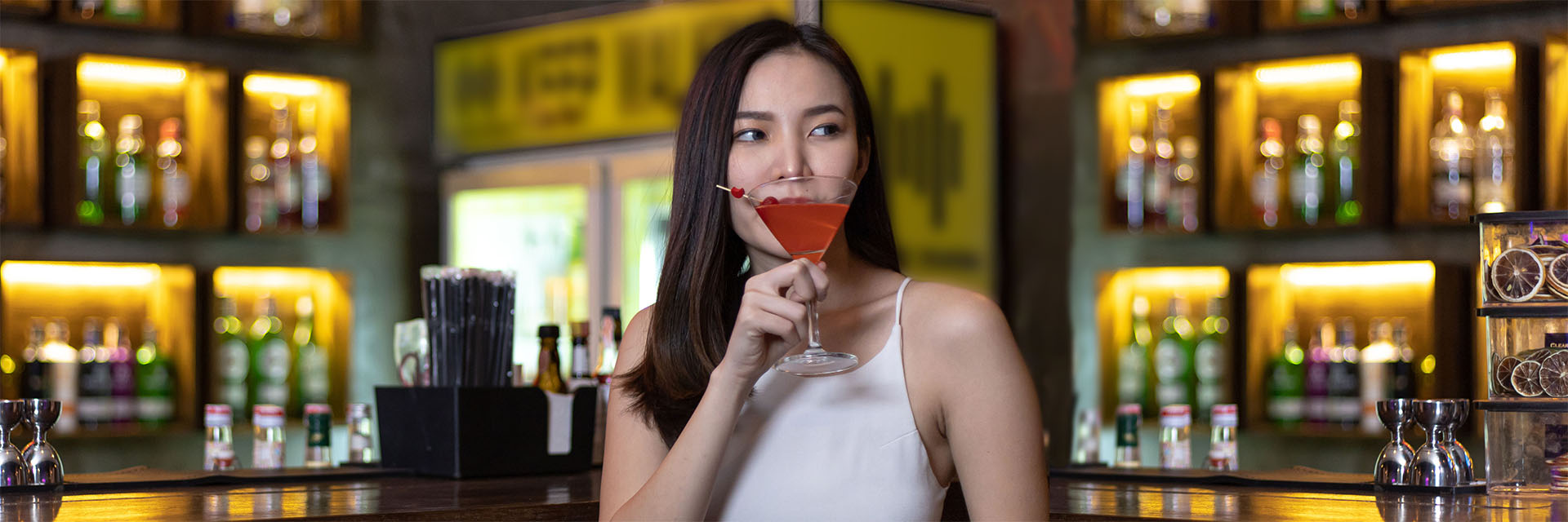 Woman drinking alone at a bar