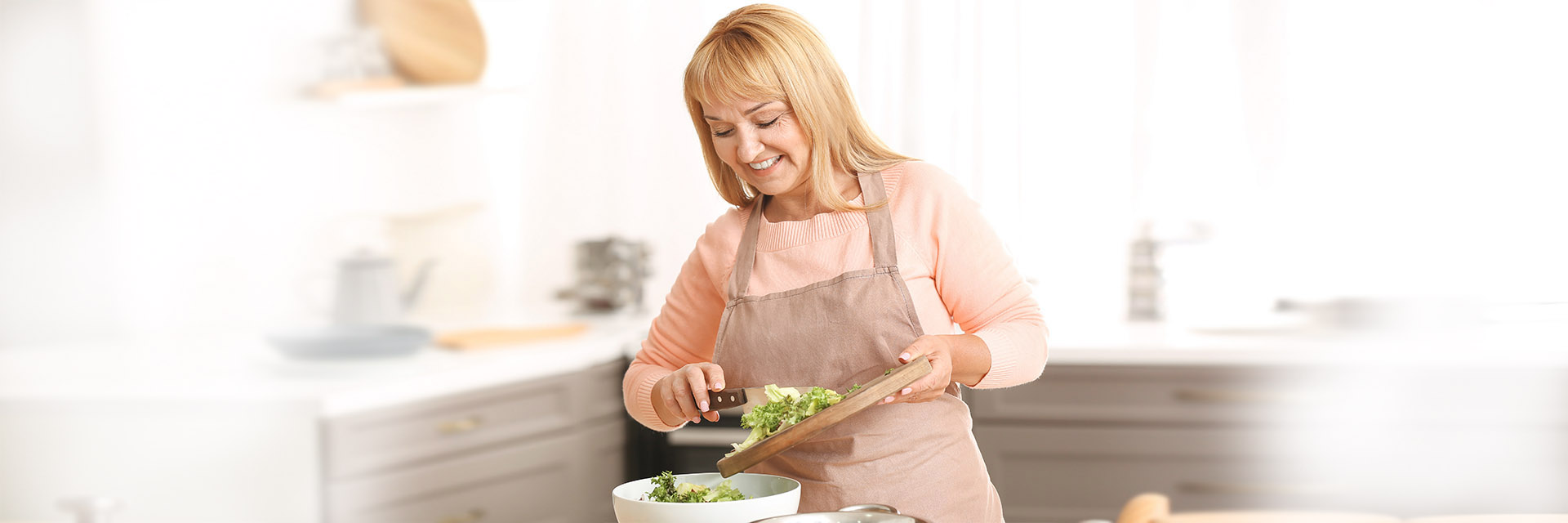 Woman putting chopped food into pot