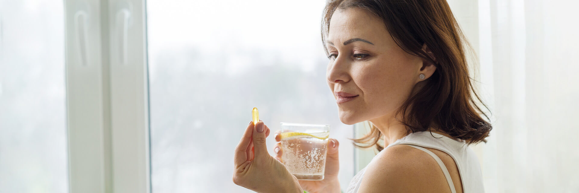 Woman taking clear capsule